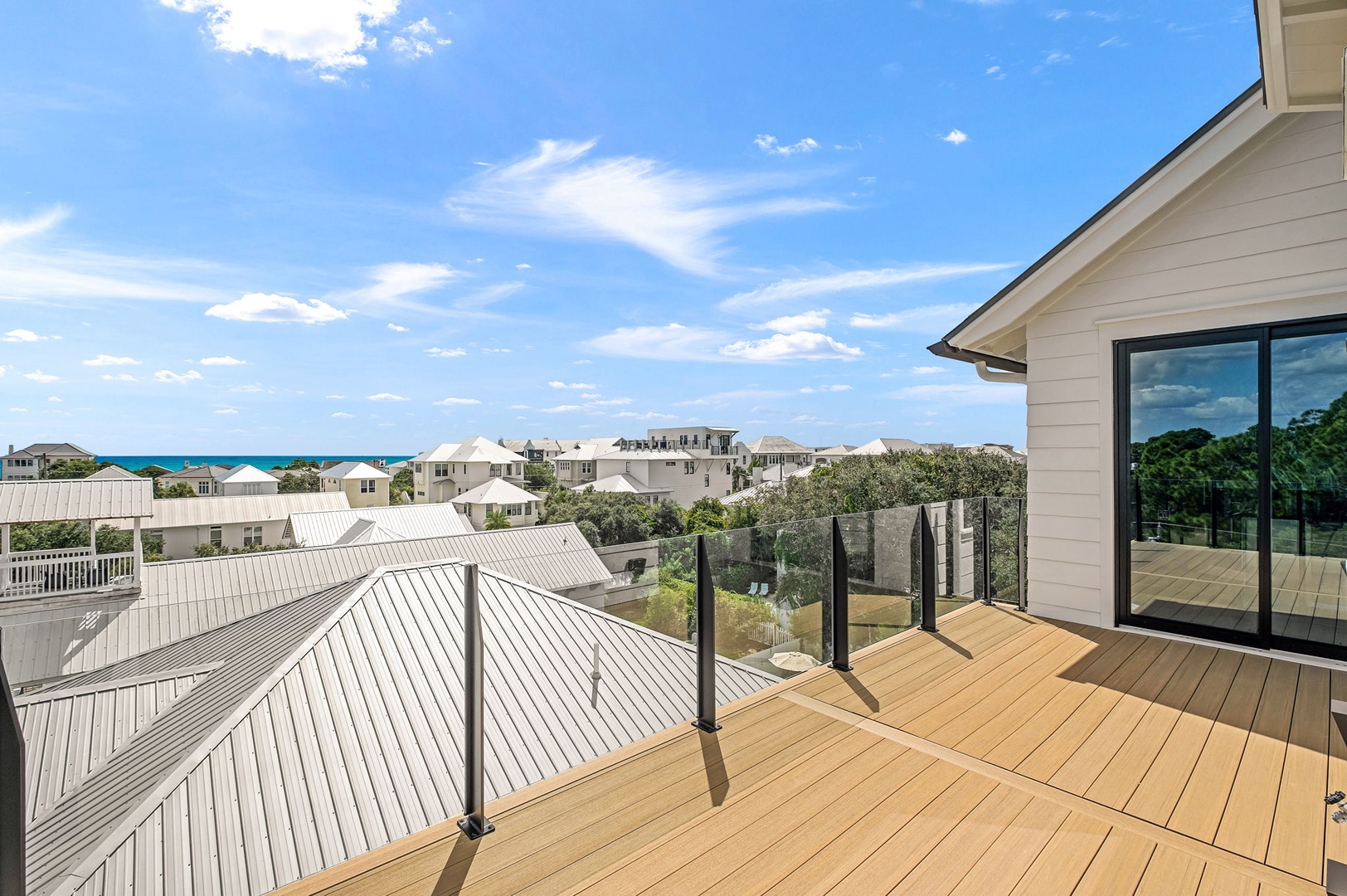 A sun-drenched deck overlooking charming coastal rooftops and hints of the sparkling sea beyond, offering your perfect perch for morning coffee or evening wine.