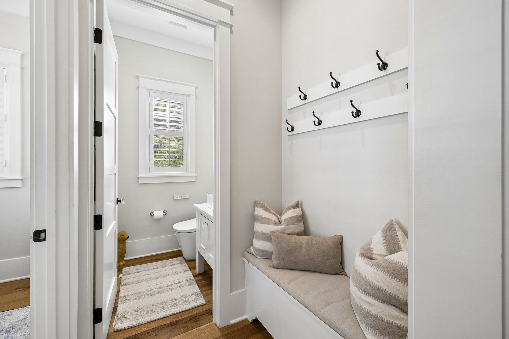 Settle into your cozy built-in bench after a day of adventure—hang up your jacket, stow your gear, and relax in this charming mudroom nook designed just for your comfort.