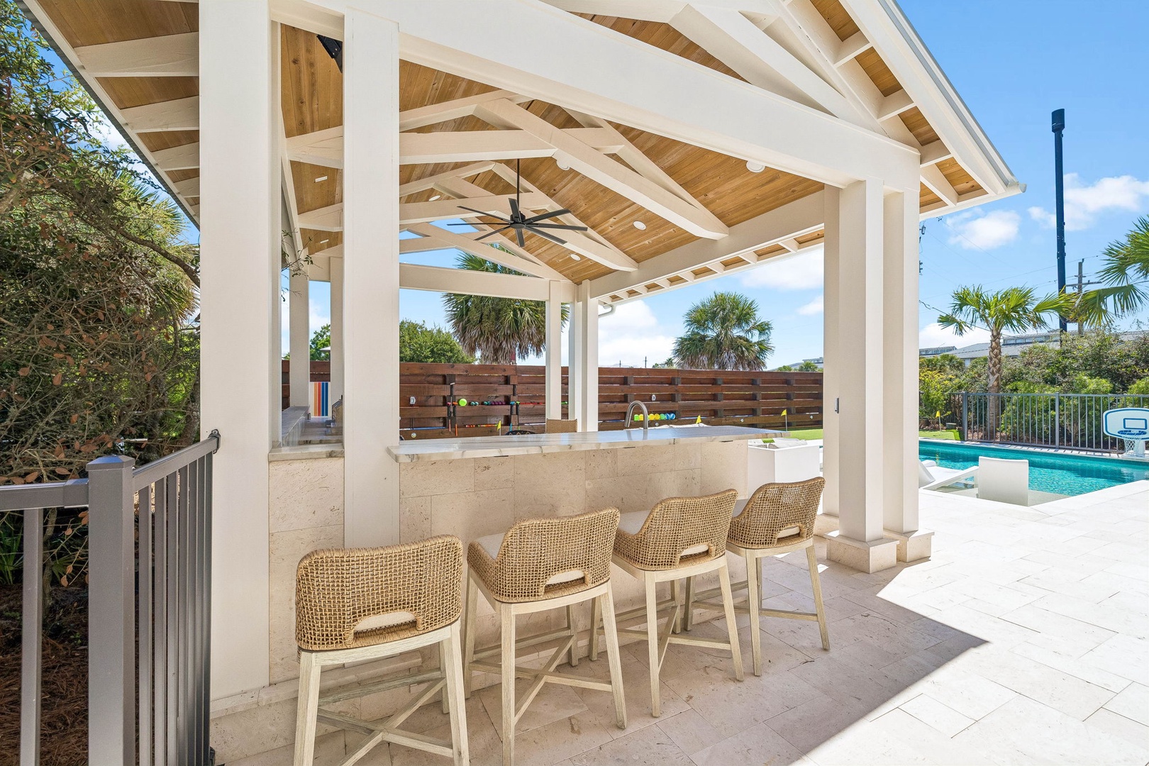 Your covered poolside bar awaits, complete with comfortable seating and tropical views. Gather here for refreshing drinks while soaking in the Florida sunshine and breeze.