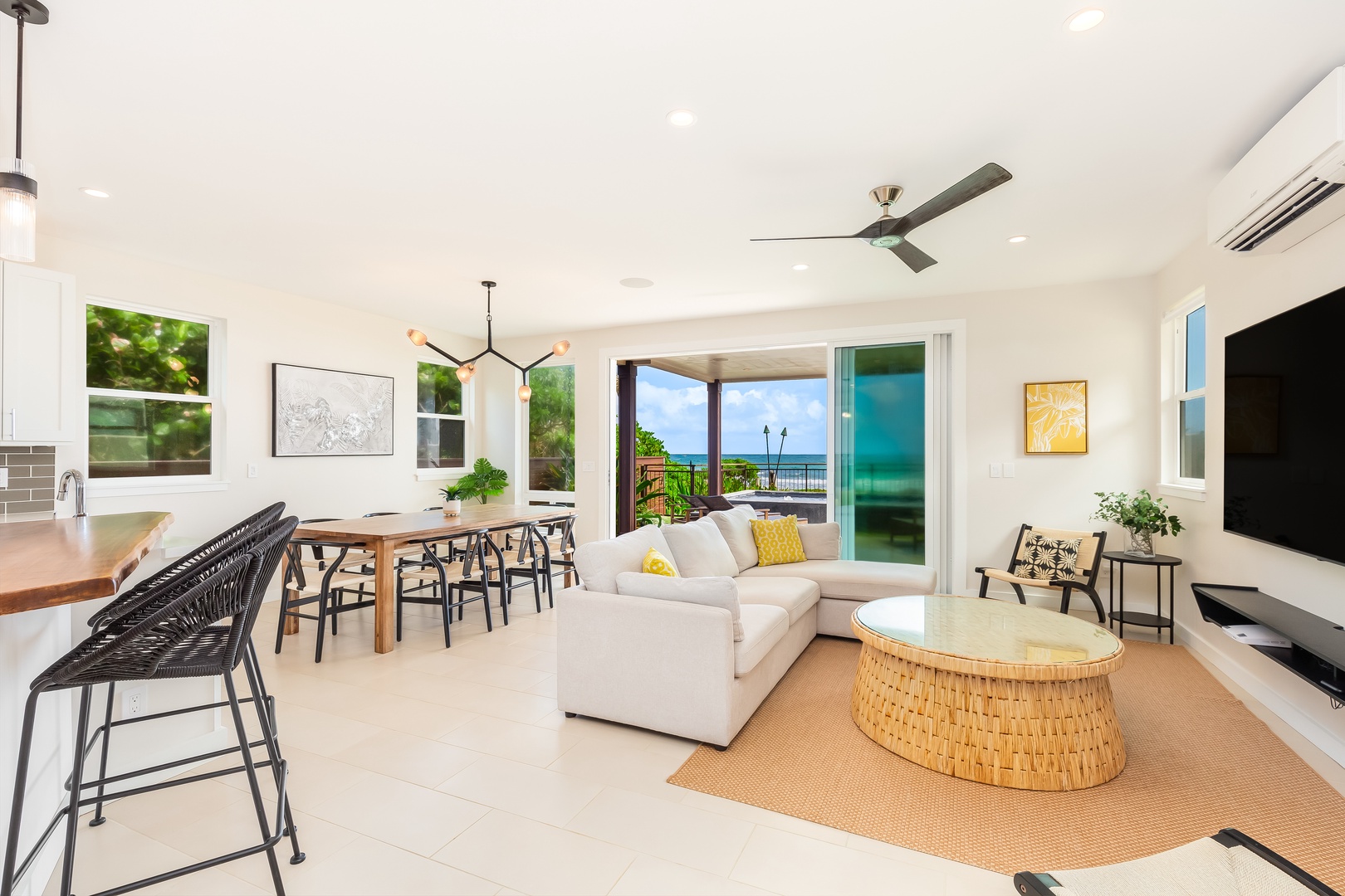 Laie Vacation Rentals, Majestic Mahakea Oceanfront Oasis - Open-plan living and dining area with stunning ocean views through floor-to-ceiling windows.