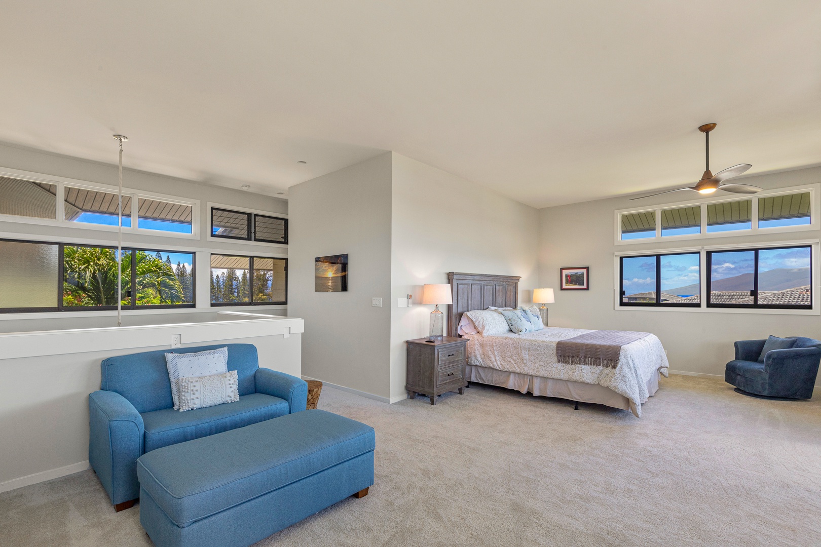 Lahaina Vacation Rentals, Kapalua Ridge 1622 - The spacious bedroom offers a serene retreat with a plush king-size bed and cozy seating area. This blue couch is a pull-out single bed as well, adding extra convenience for additional guests.