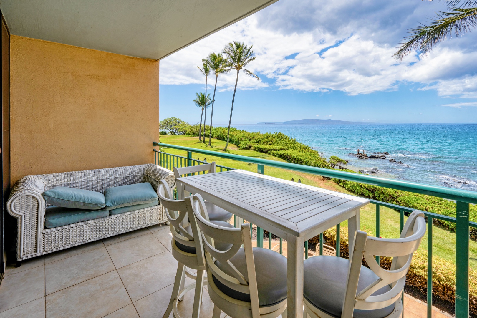 Kihei Vacation Rentals, Punahoa Beach 205 - A wicker loveseat and dining table share the lanai so nobody lacks a view of the water.