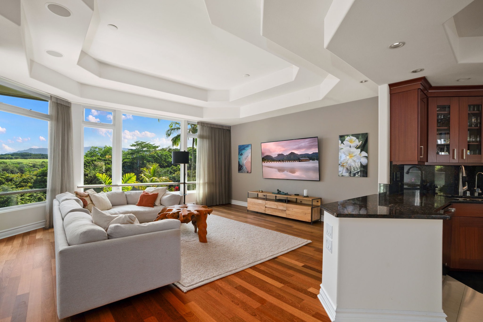 Princeville Vacation Rentals, Kaiulani #8 - Settle into the white sofa with green hills framed through the windows.