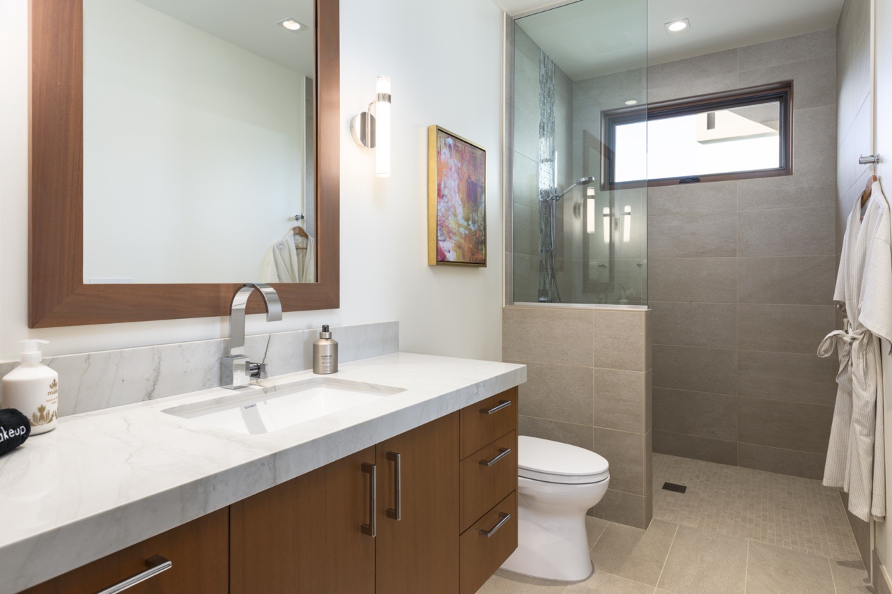 Kailua Kona Vacation Rentals, 4BR Luxury Puka Pa Estate (1201) at Hualalai Resort - Ensuite guest bathroom with a walk-in shower, custom storage and natural lighting.