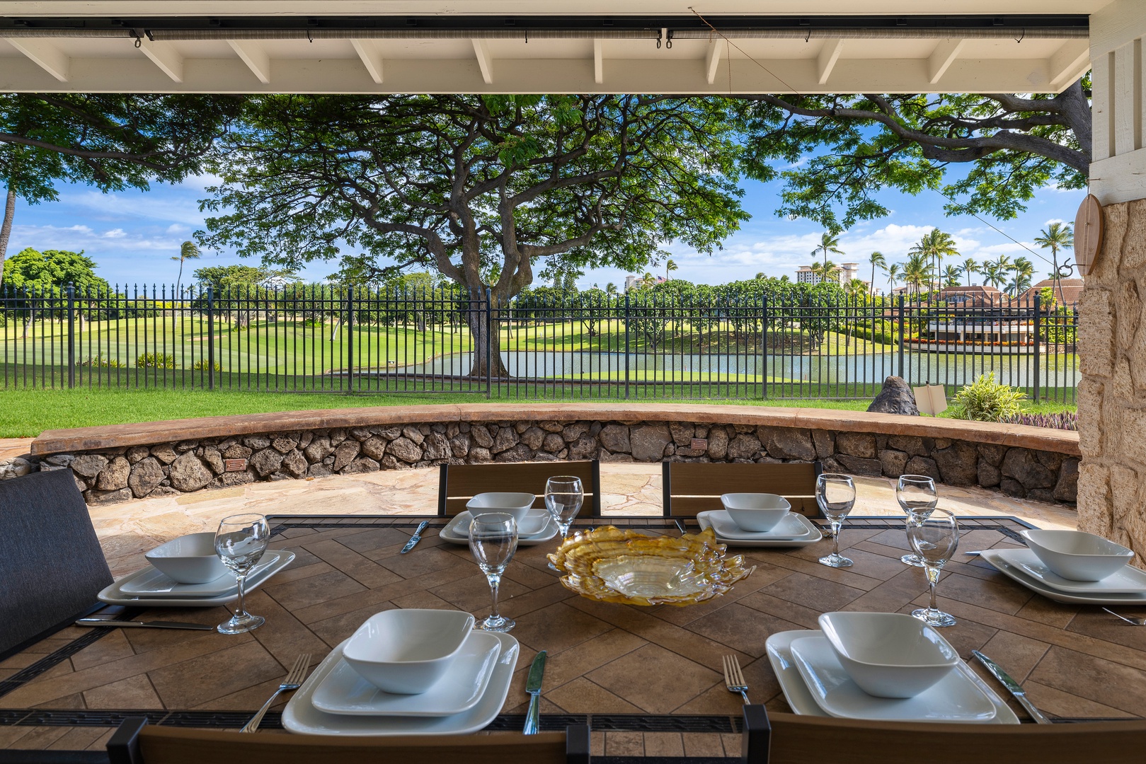 Savor meals at your private outdoor dining table with stunning golf course views and tropical scenery.
