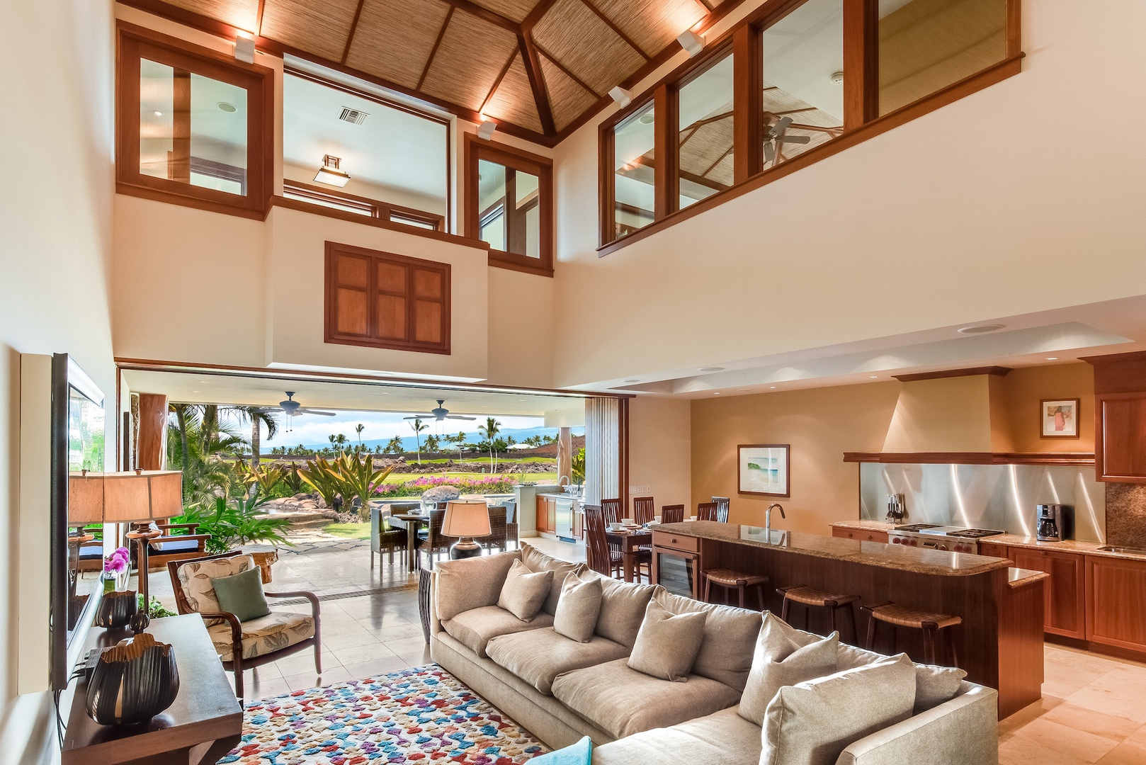 Kamuela Vacation Rentals, 3BD Ke Kailani (1C) at Mauna Lani Resort - Spacious & Elegantly Appointed Living Room w/ Vaulted Ceilings & Electronic Pocket Doors that Open to Lanai and Pool Area
