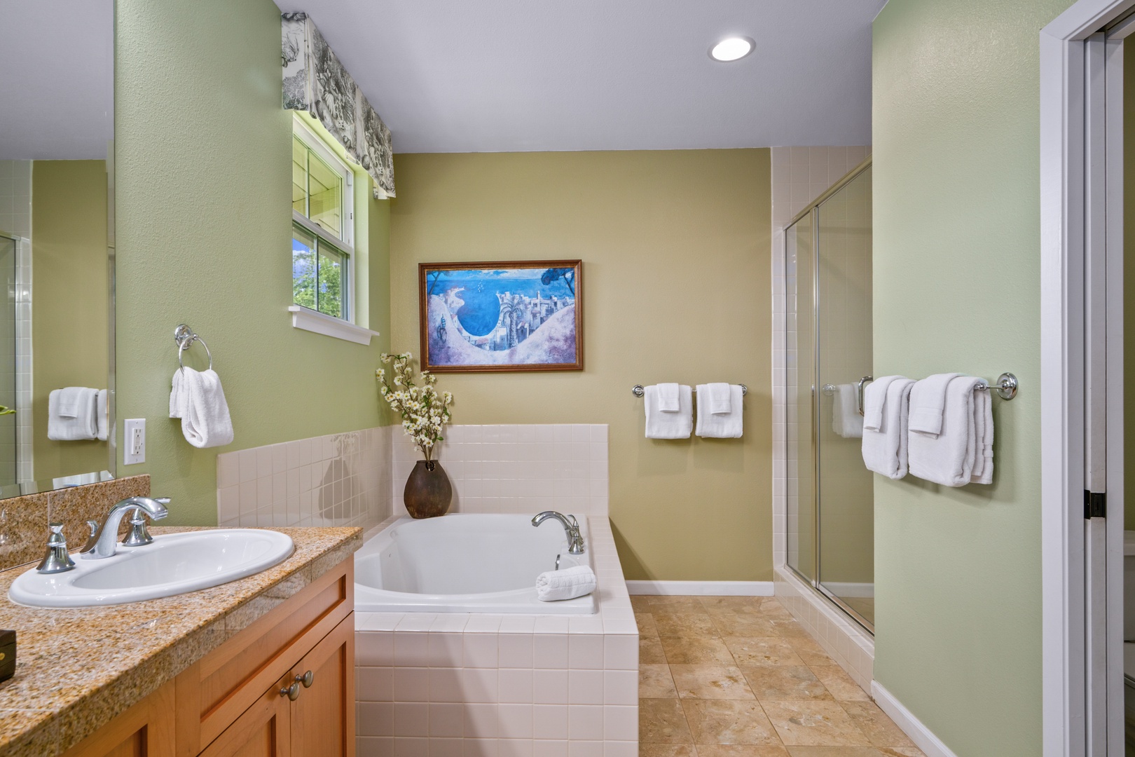 Princeville Vacation Rentals, Kaimana Villa - Unwind in your spacious bathroom featuring a soaking tub, walk-in shower, and soothing green walls that create your perfect retreat.