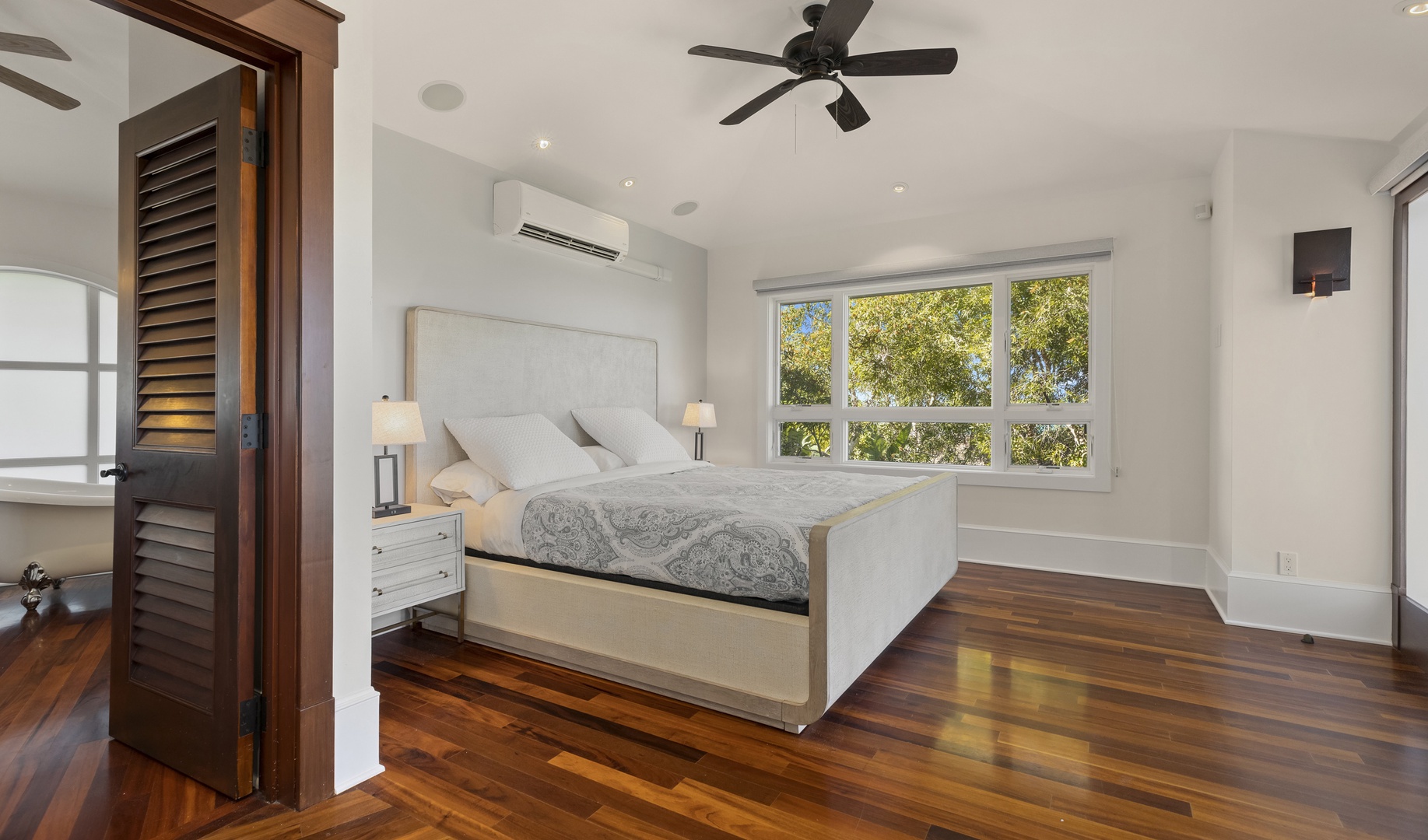Kailua Vacation Rentals, Lanikai Villa - The Primary Bedroom is furnished with a king bed, split A/C, ceiling fan, and ensuite bathroom