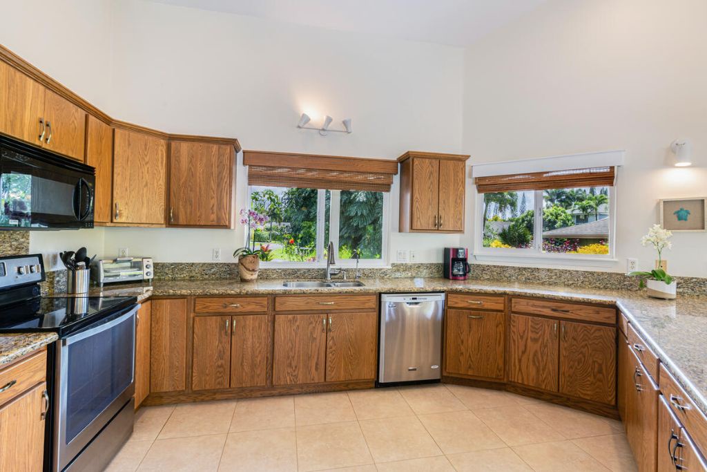 Princeville Vacation Rentals, Hale Cassia - The kitchen has wide counter spaces, stainless steal appliances and plenty of storage options