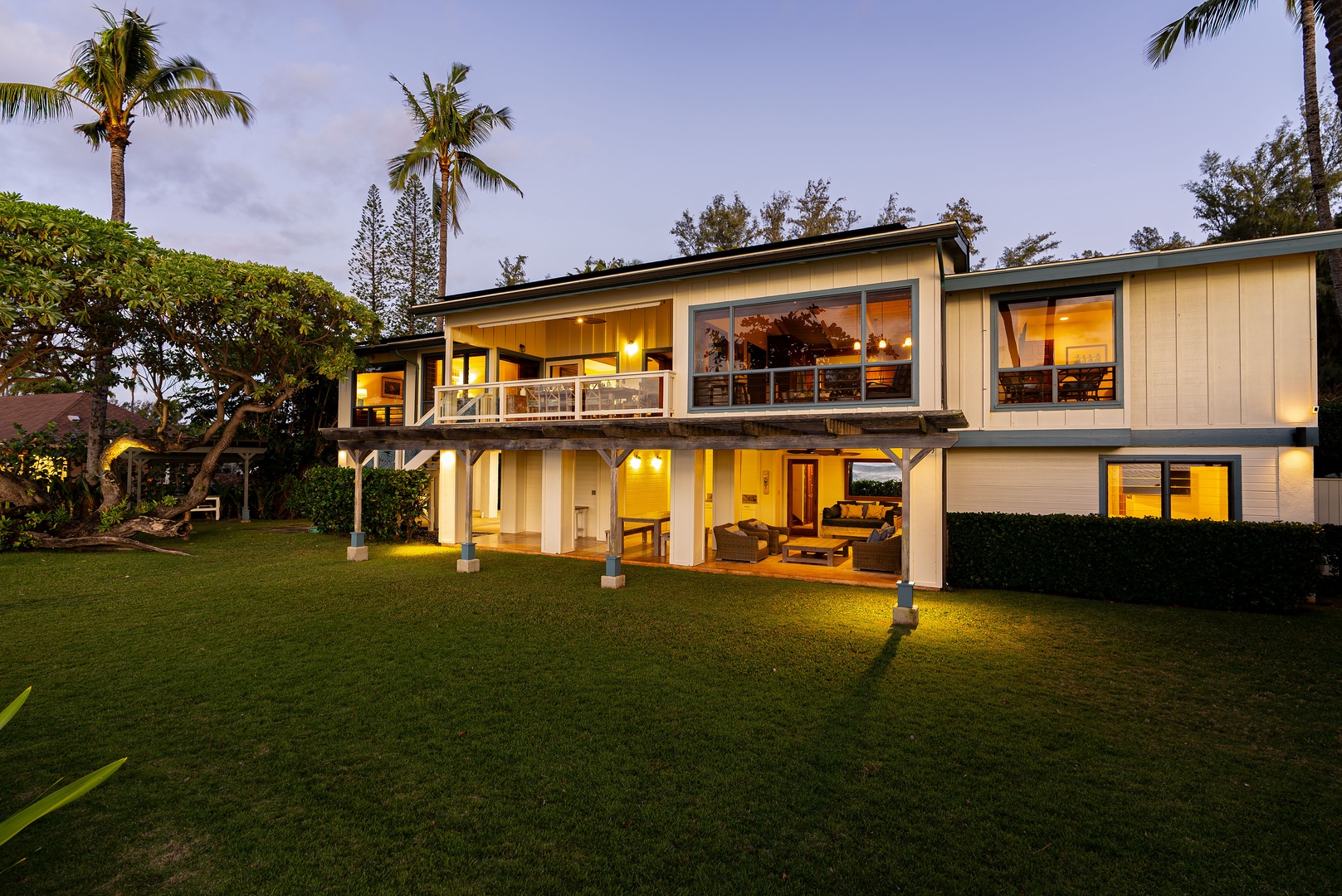 Haleiwa Vacation Rentals, Maluhia Beach House - The home’s beautiful architecture shines at sunset, creating a magical evening glow.