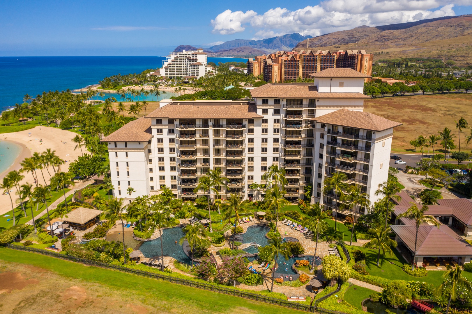 Kapolei Vacation Rentals, Ko Olina Beach Villas B109 - The Beach Villas cluster along the shore, pools and gardens tucked between.