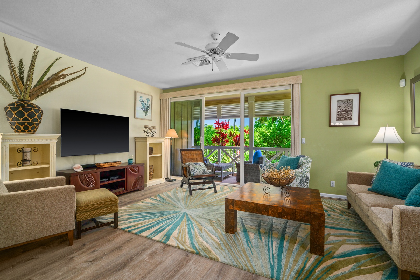 Princeville Vacation Rentals, Kaimana Villa - Unwind in your tropical-themed living room with vibrant colors, comfortable seating, and garden views through sliding doors.