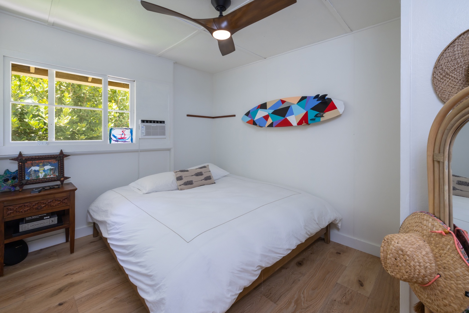 Kahuku Vacation Rentals, Hale Pellicano - The guest bedroom two with queen-sized bed, window AC and garden view.