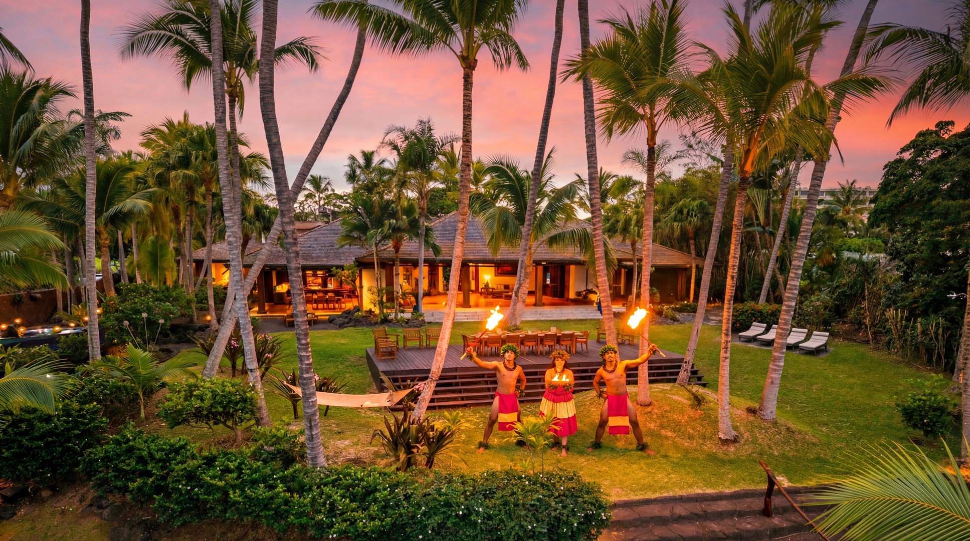 Kailua-Kona Vacation Rentals, Hahalua Bay Villa - Tropical villa surrounded by swaying palms under a stunning sunset sky, featuring traditional torch-lit cultural performance on manicured grounds.
