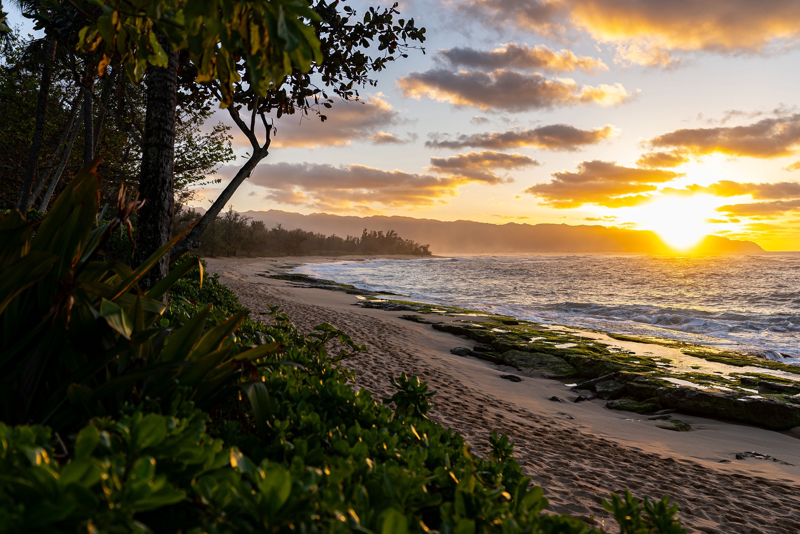 Haleiwa Vacation Rentals, Maluhia Beach House - Experience breathtaking sunsets right from the beach, just steps from your stay.