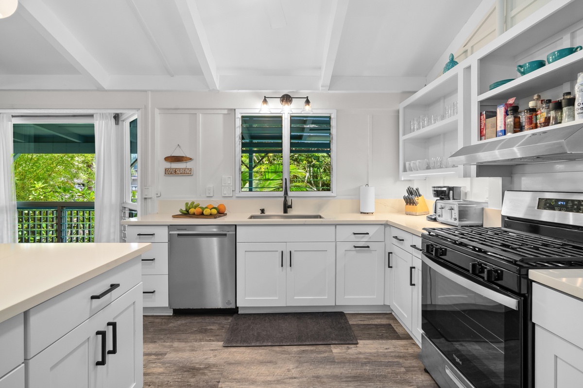 Hanalei Vacation Rentals, Hale Kanani (Kaua'i) TVNC 1342 - The range and open shelves sit in a bright corner, everything within easy reach.