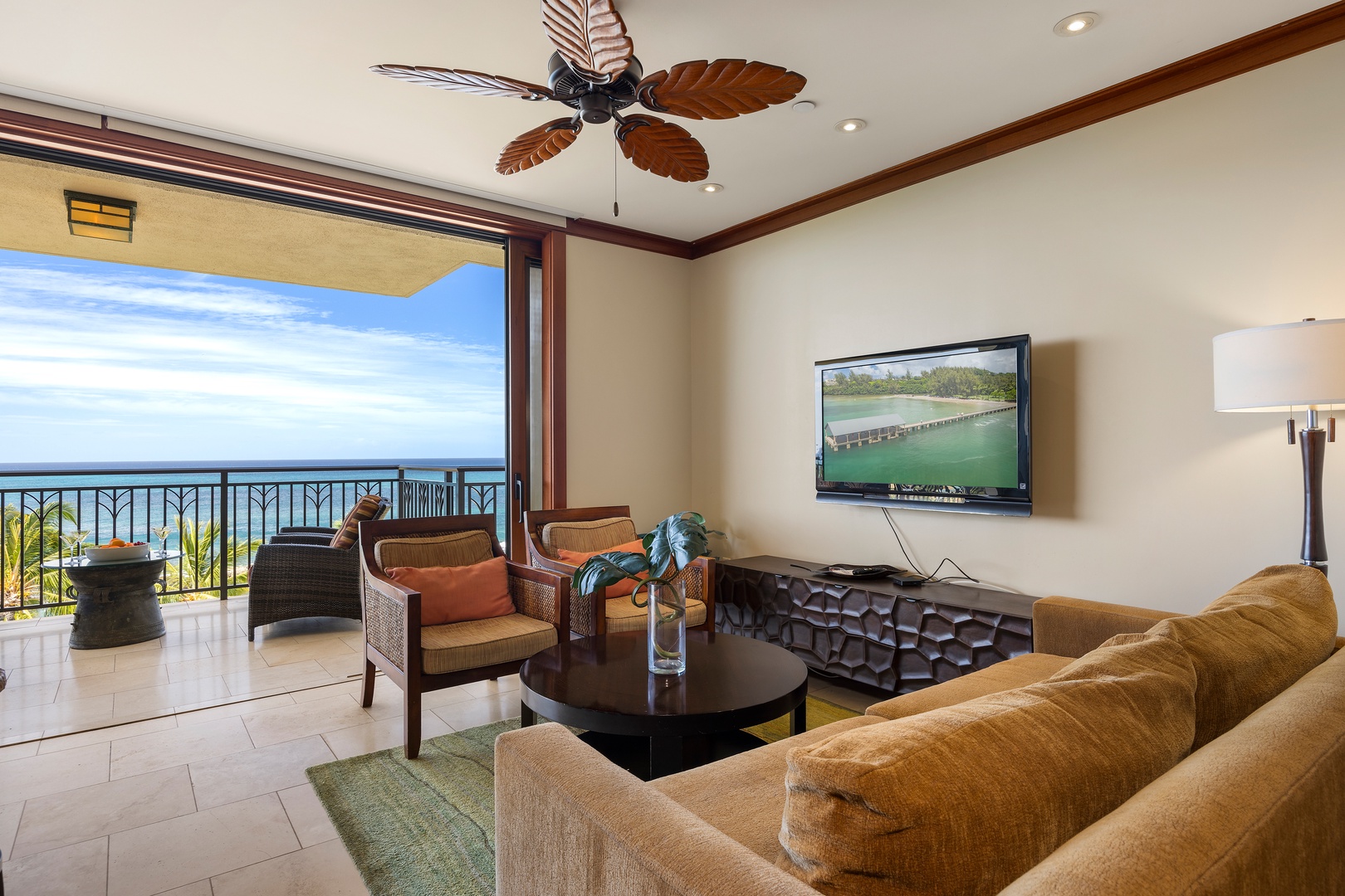 Kapolei Vacation Rentals, Ko Olina Beach Villas B609 - Unwind in your spacious living room with stunning ocean views, tropical ceiling fan, and comfortable seating perfect for relaxing evenings.