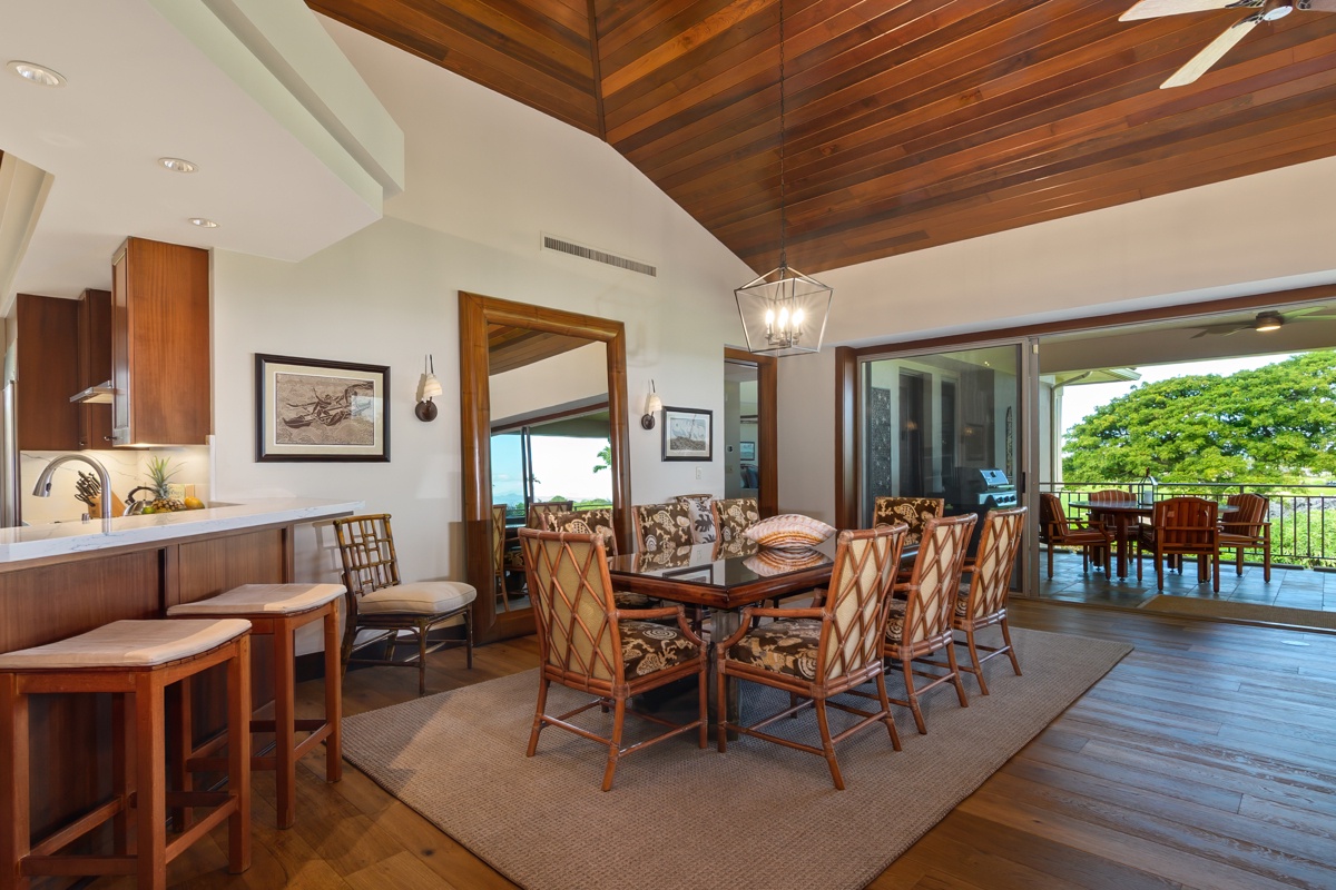 Kailua Kona Vacation Rentals, Fairways Villa 120A - Savor your meals in this elegant open-plan space where rich wood and tropical views create the perfect dining atmosphere.