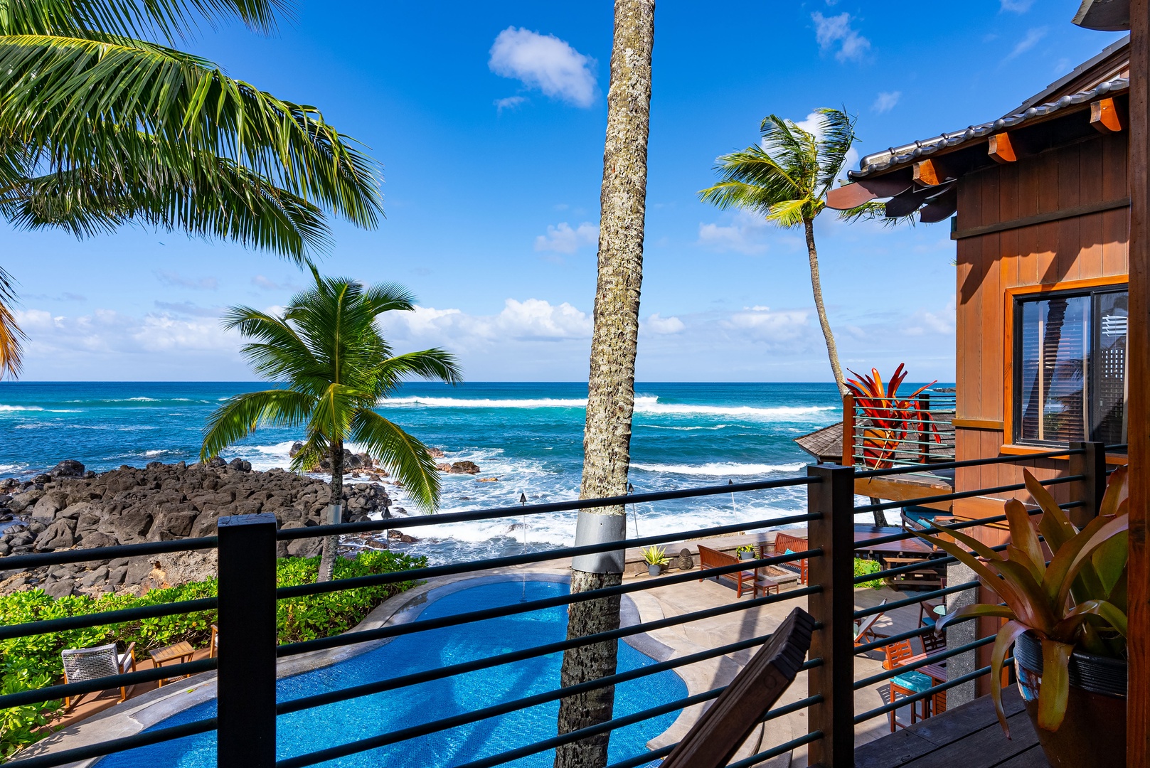 Haleiwa Vacation Rentals, Samurai House - Balcony with breathtaking views of the sparkling ocean and swaying palm trees.