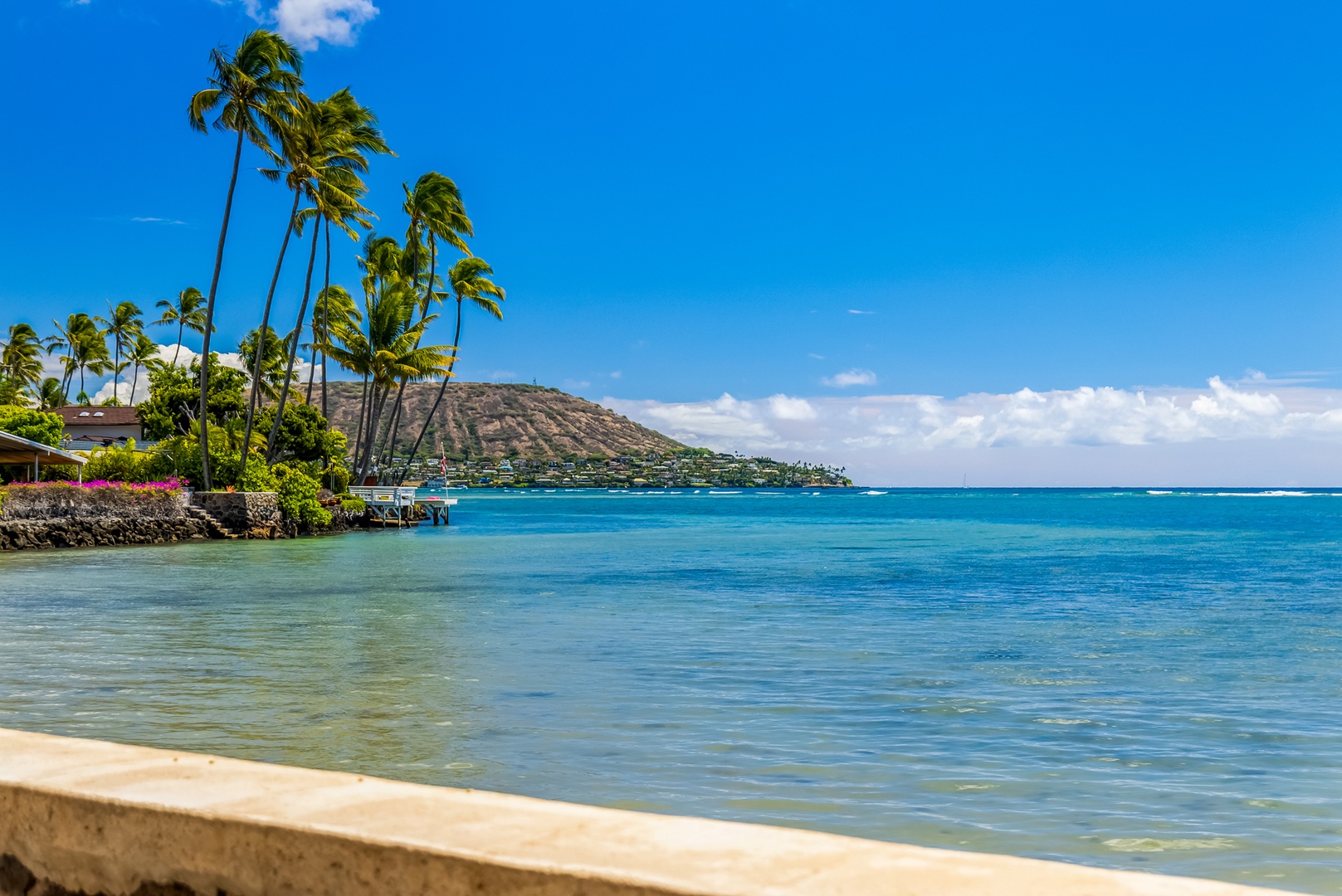 Honolulu Vacation Rentals, Moana Lani - Main House - Diamond Head on the horizon and clear turquoise water right off the seawall.