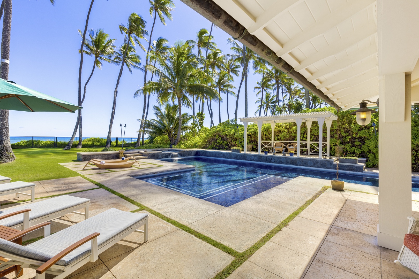 Honolulu Vacation Rentals, Kahala Beachside Estate - Enjoy palm trees swaying as you recline on the chaise lounges