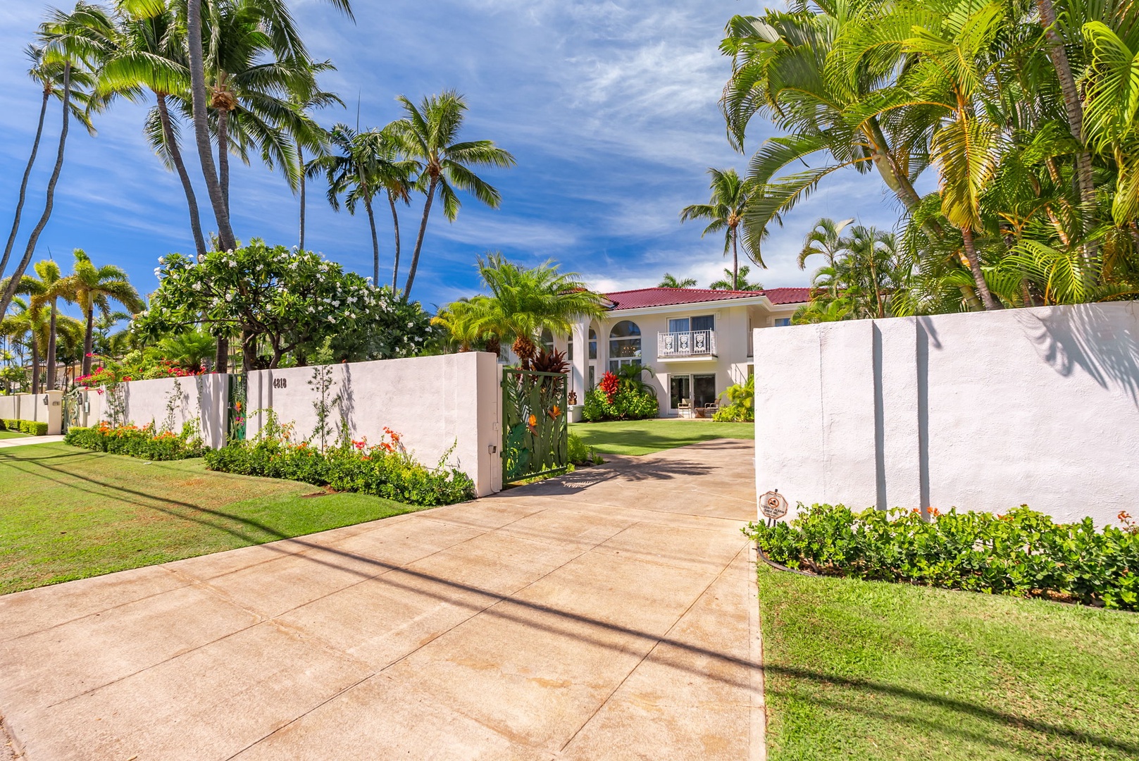 Honolulu Vacation Rentals, Kahala Oasis - Private entrance gate framed by lush landscaping, offering privacy and a welcoming ambiance to the villa.