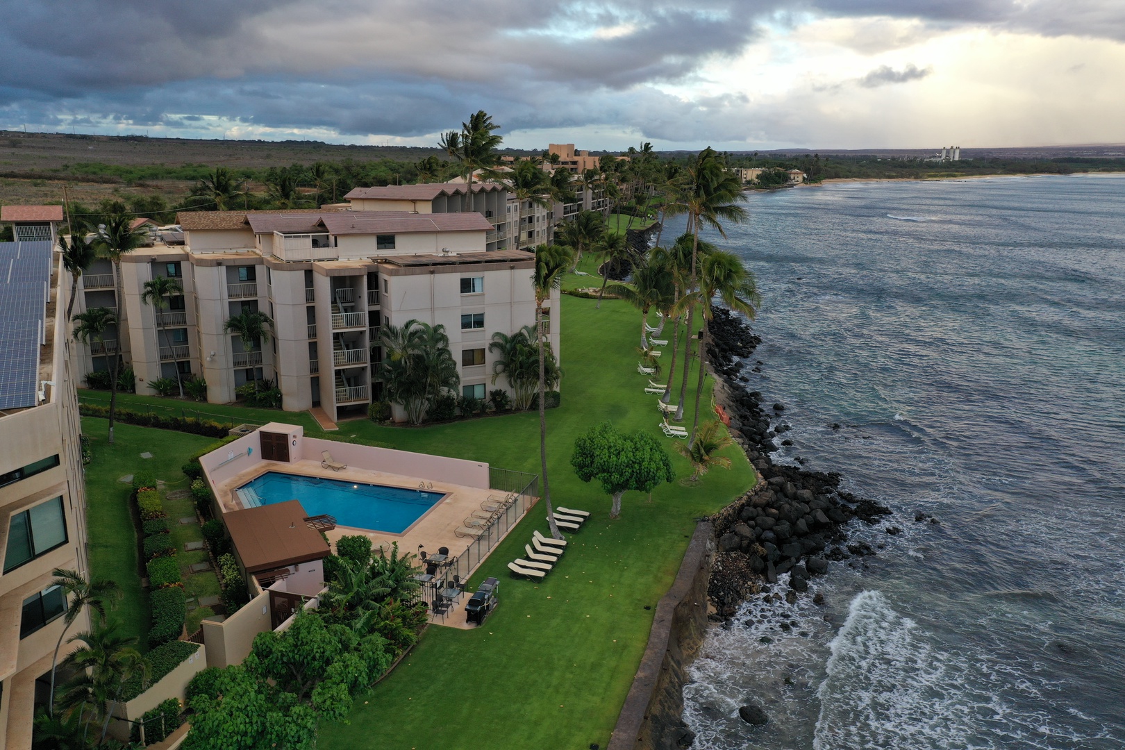 Wailuku Vacation Rentals, Milowai 310 - From above, the lawn ends where the lava-rock shoreline meets the open ocean.