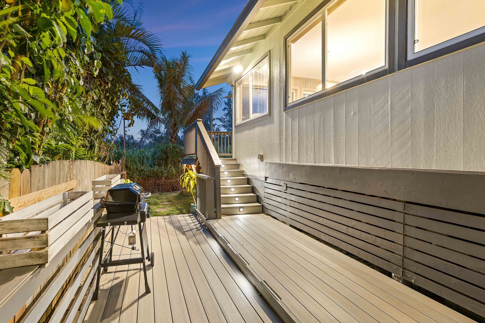 Haleiwa Vacation Rentals, Velzey Villa (3B Vacation Home) - Soft lighting creates a welcoming glow along the deck at sunset.