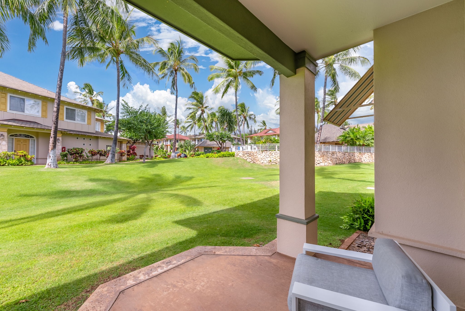 Kapolei Vacation Rentals, Kai Lani Luxury 6D - Scenic view from the lanai, showcasing lush greenery and palm trees for a true island paradise experience.