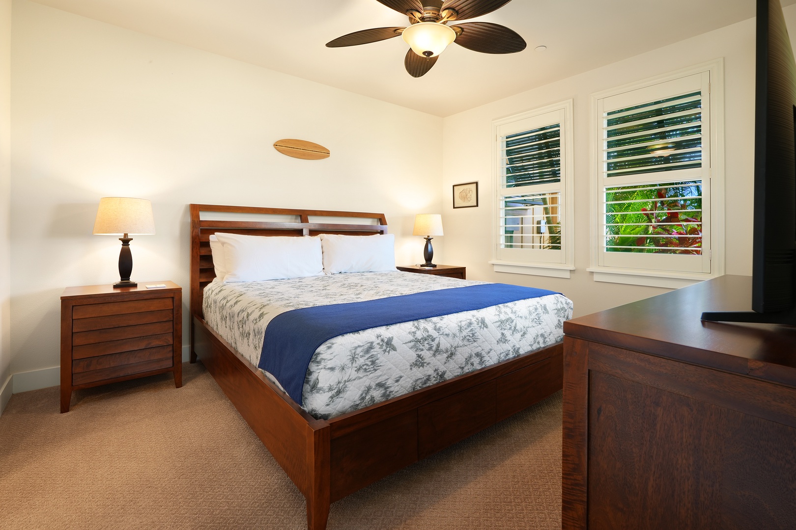 Koloa Vacation Rentals, Pili Mai 6J - Unwind in your serene bedroom sanctuary with tropical ceiling fan, elegant wood furnishings, and peaceful garden views through your windows.
