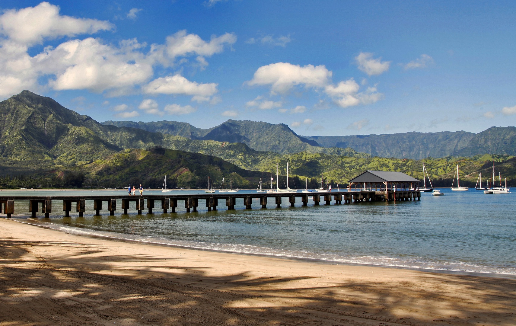 Koloa Vacation Rentals, Ke Kai Nui at Kukuiula - Hanalei Bay with its iconic pier, turquoise waters, and a breathtaking mountain backdrop.