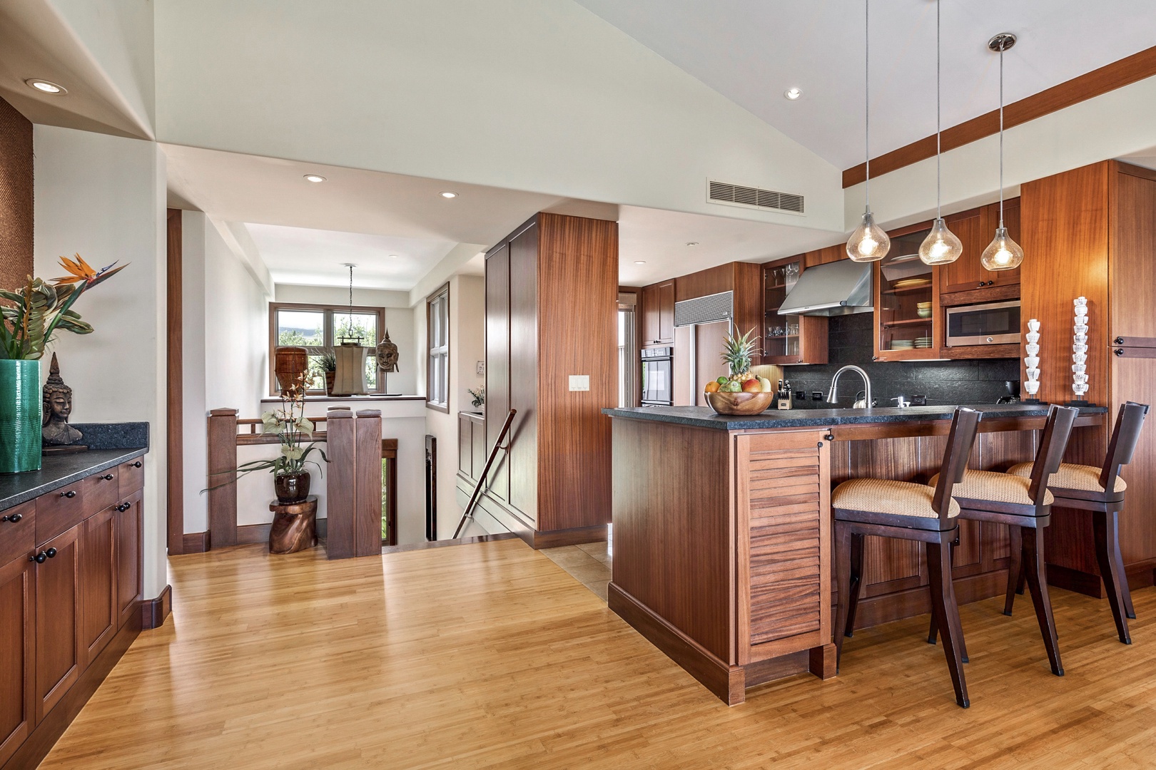 Kailua Kona Vacation Rentals, 3BD Ka'Ulu Villa (131C) at Four Seasons Resort at Hualalai - Wider view of upper level with bar seating into the open floor plan kitchen.