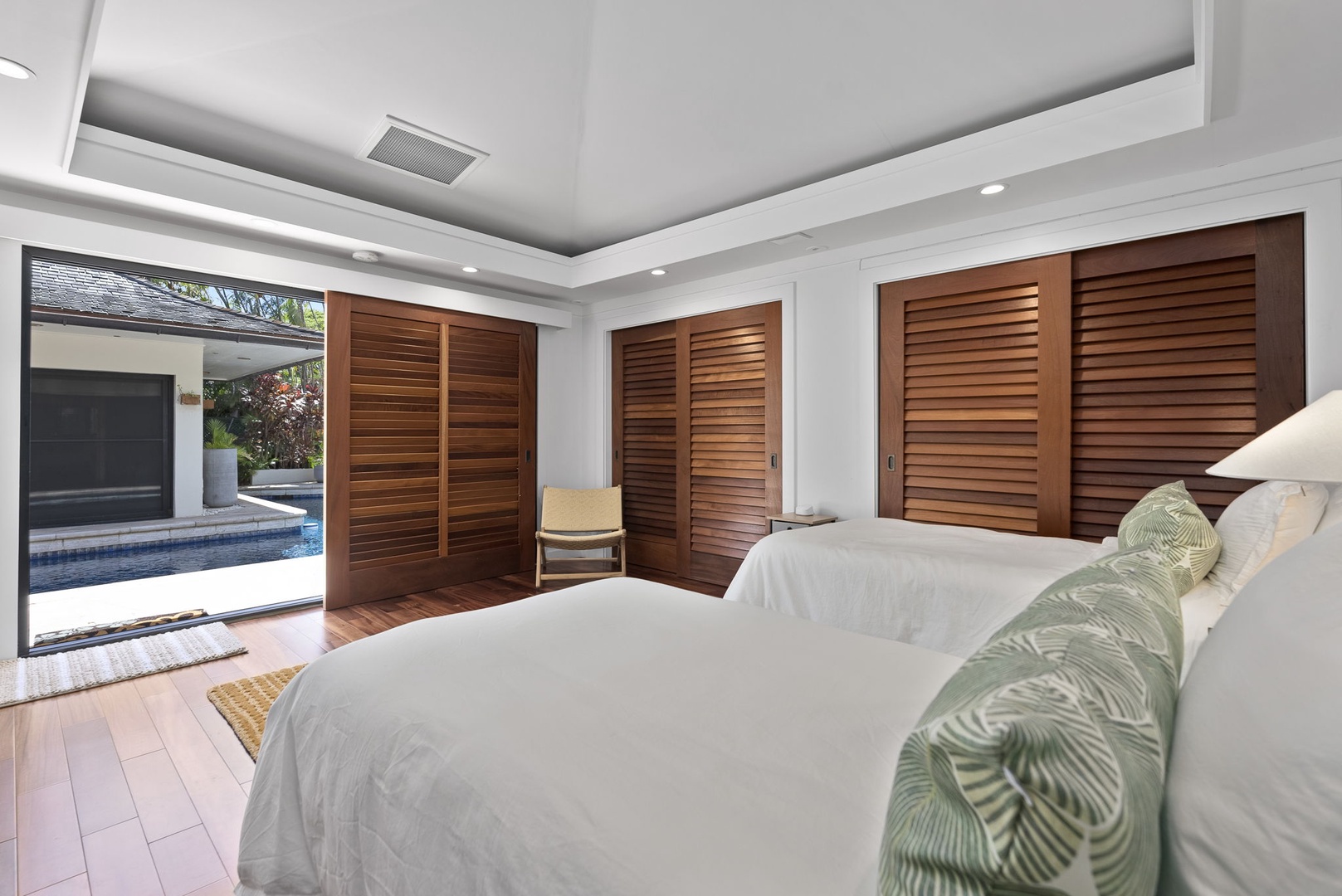Honolulu Vacation Rentals, Honolulu Lagoonfront Villa - Every suite offers its own character—this room features lanai access and leafy green views.