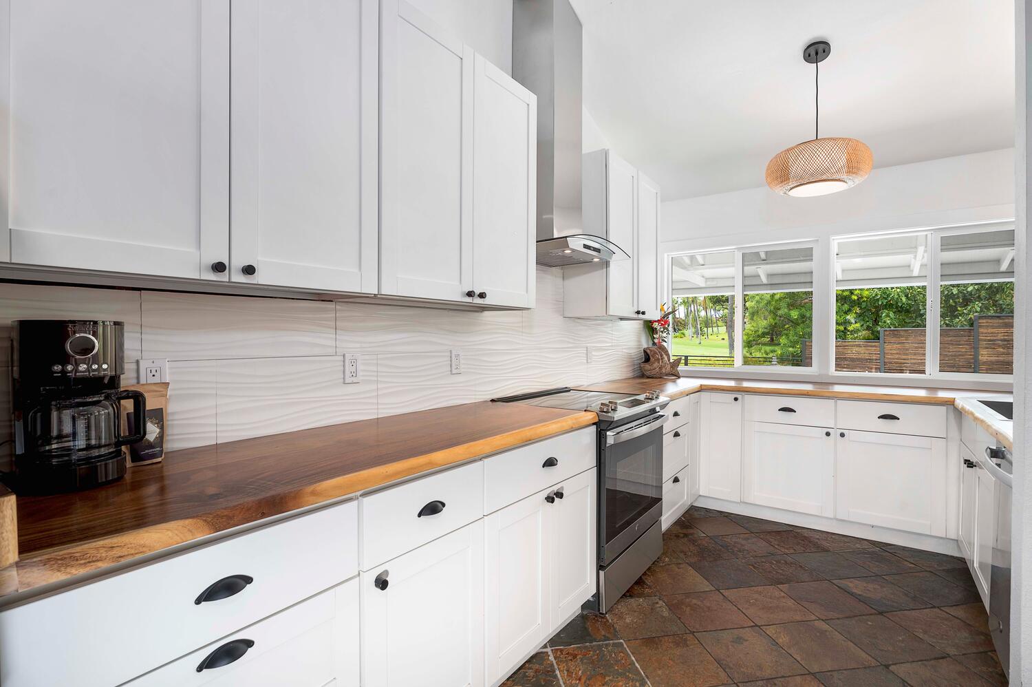 Kailua Kona Vacation Rentals, Manukai Hale - Cook like a pro in the modern kitchen with wide counters and natural light streaming in.