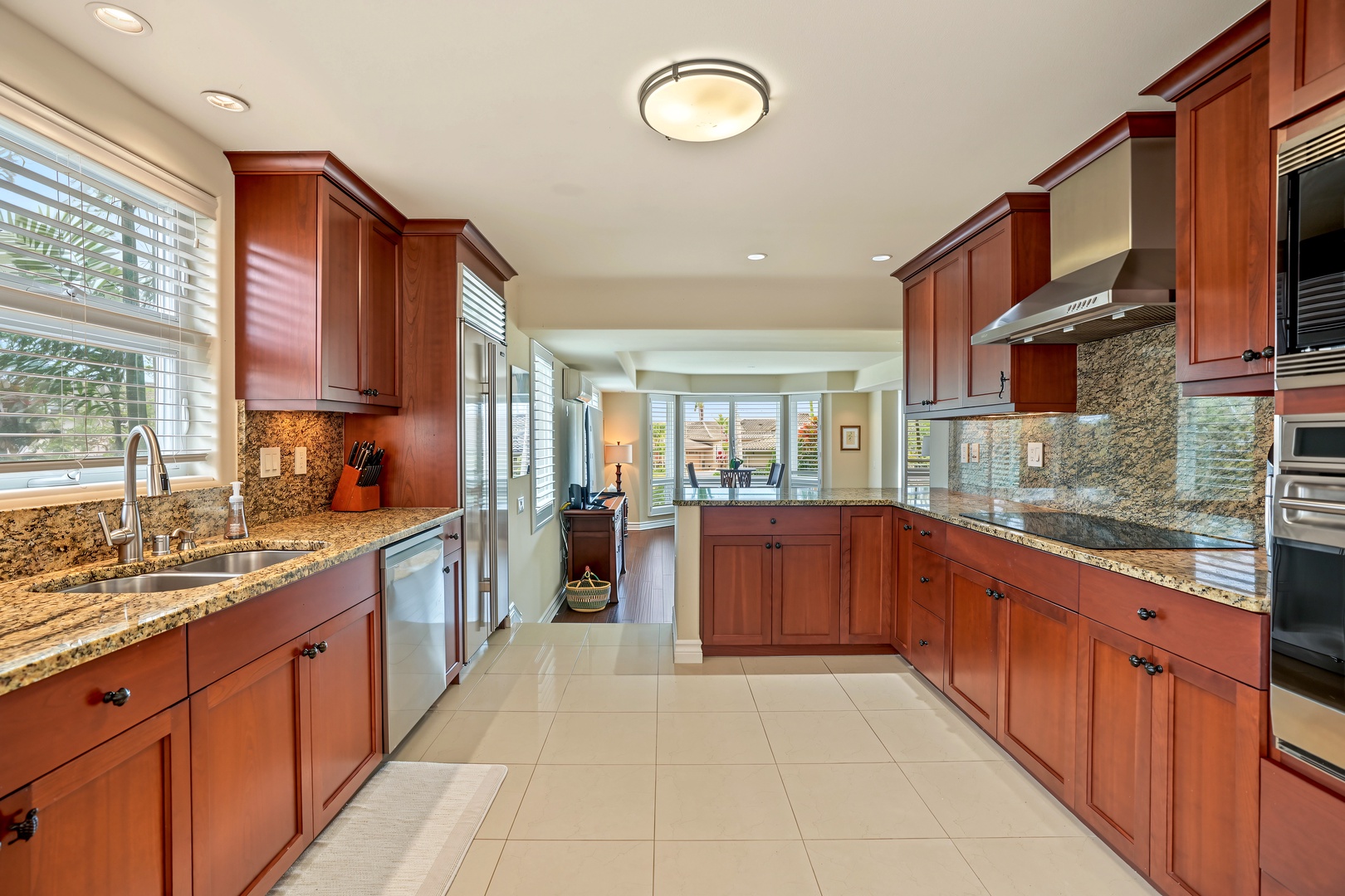 Princeville Vacation Rentals, Hale Hau'oli Moku - Cherry cabinets and granite counters run long enough for two cooks to work without trading elbows.