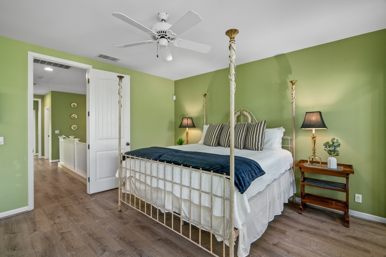 Princeville Vacation Rentals, Kaimana Villa - Unwind in your tranquil bedroom where soothing green walls and elegant brass four-poster bed create perfect sanctuary for restful nights.