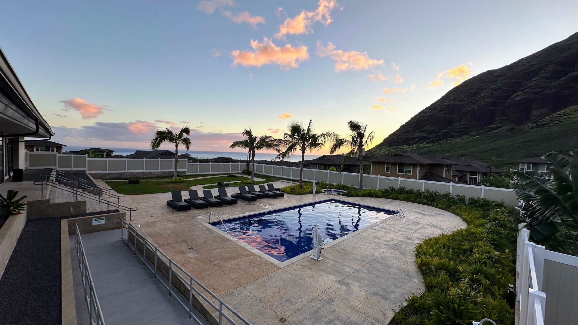 Makaha Valley Vacation Rentals, Makaha Valley Hale Kai** - Pool at golden hour, glowing with colors of the Hawaiian sunset.
