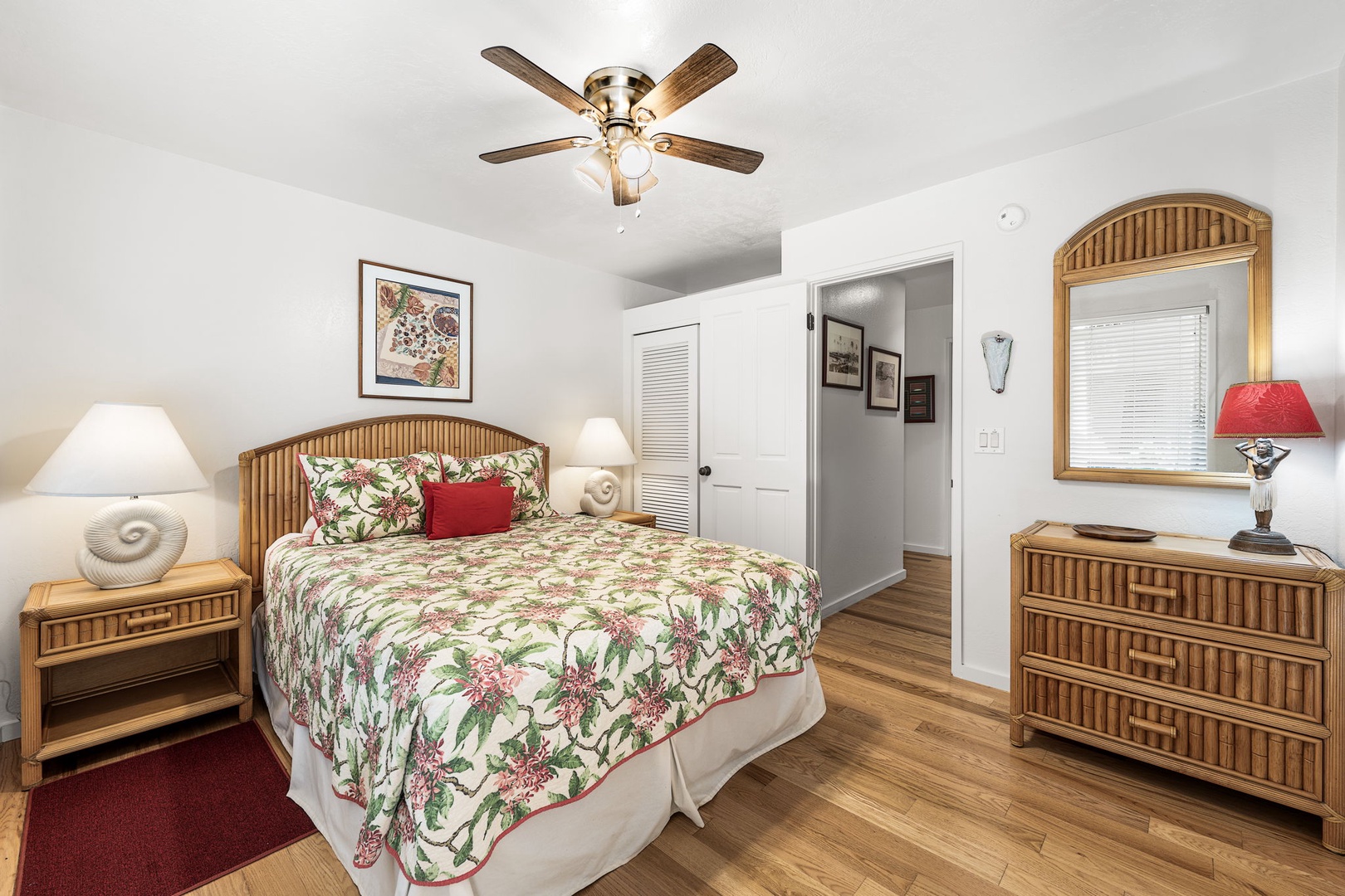 Kailua Kona Vacation Rentals, Kanaloa at Kona 701 - Unwind in your cozy bedroom featuring tropical-themed bedding, warm wood furnishings, and a gentle ceiling fan for perfect comfort.