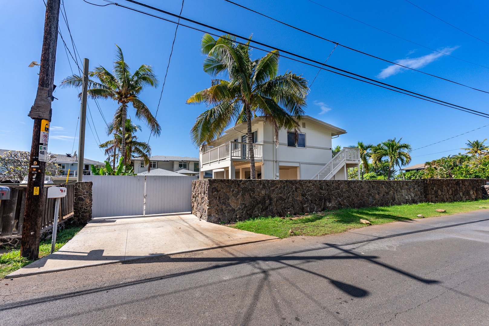Waianae Vacation Rentals, Oceanfront Luxury Dream Estate - Street view of the gated entry ensures convenience, security, and privacy in this tropical retreat.