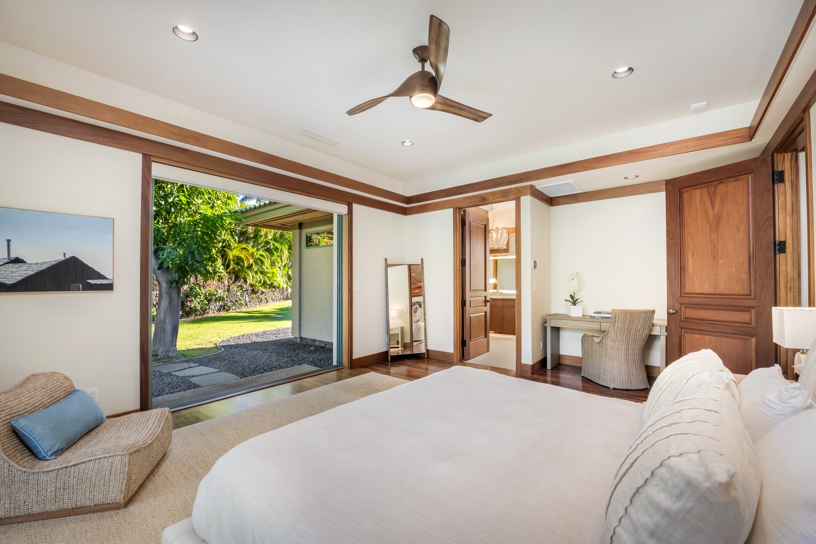 Kamuela Vacation Rentals, Champion Ridge Oasis - Primary bedroom featuring a luxurious king-size bed with a cozy work space, gorgeous ensuite bath, walk-in closet and direct access to the private garden through two large pocket doors.