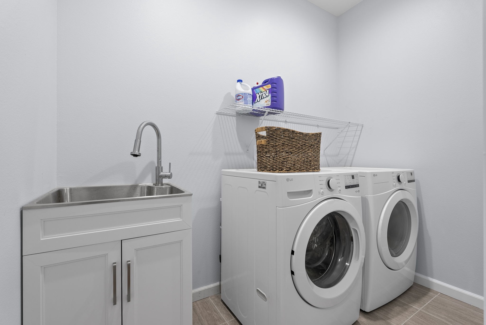Waianae Vacation Rentals, Oceanfront Luxury Dream Estate - Upper-level laundry includes front-loading washer/dryer, utility sink, and storage cabinets.