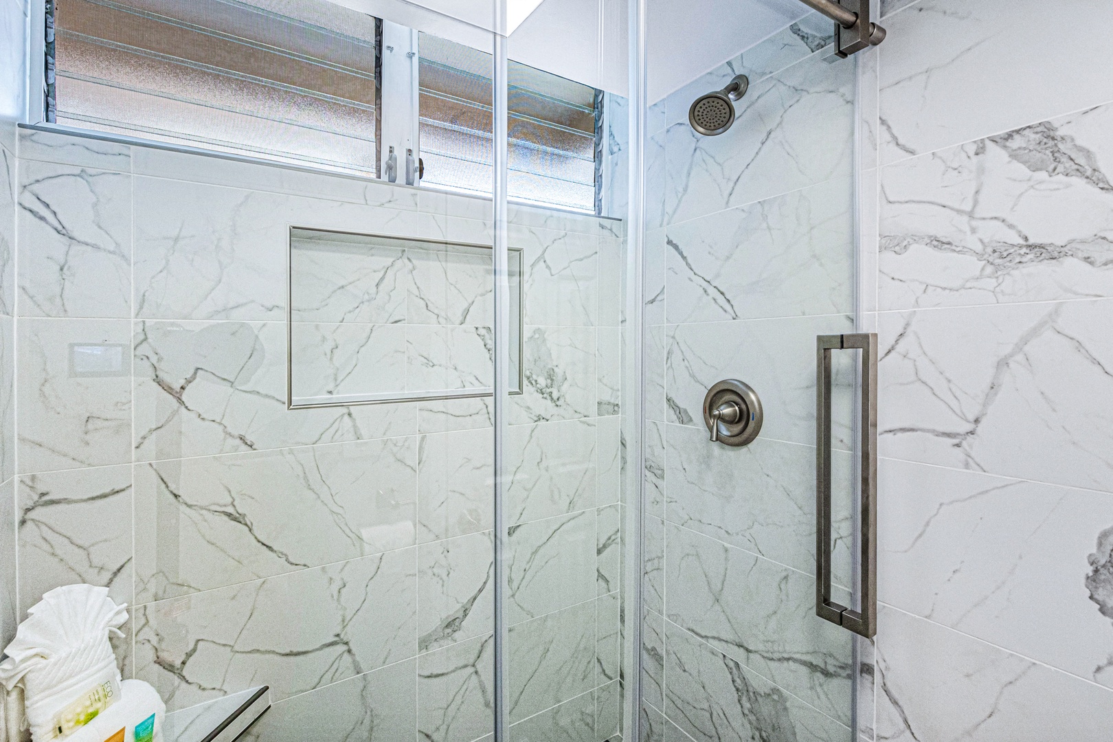 Lahaina Vacation Rentals, Royal Kahana 213 - The walk-in shower features elegant marble-style tiles and a glass enclosure, providing a sleek and modern space to refresh.