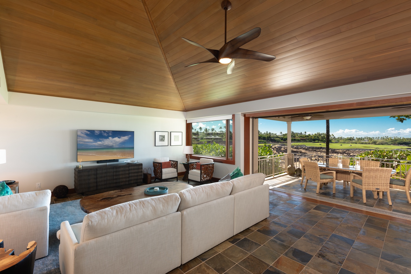 Kailua Kona Vacation Rentals, 3BD Waiulu Villa (111D) at Hualalai Resort - Inviting living area with comfortable seating, a rustic coffee table, and seamless outdoor access.