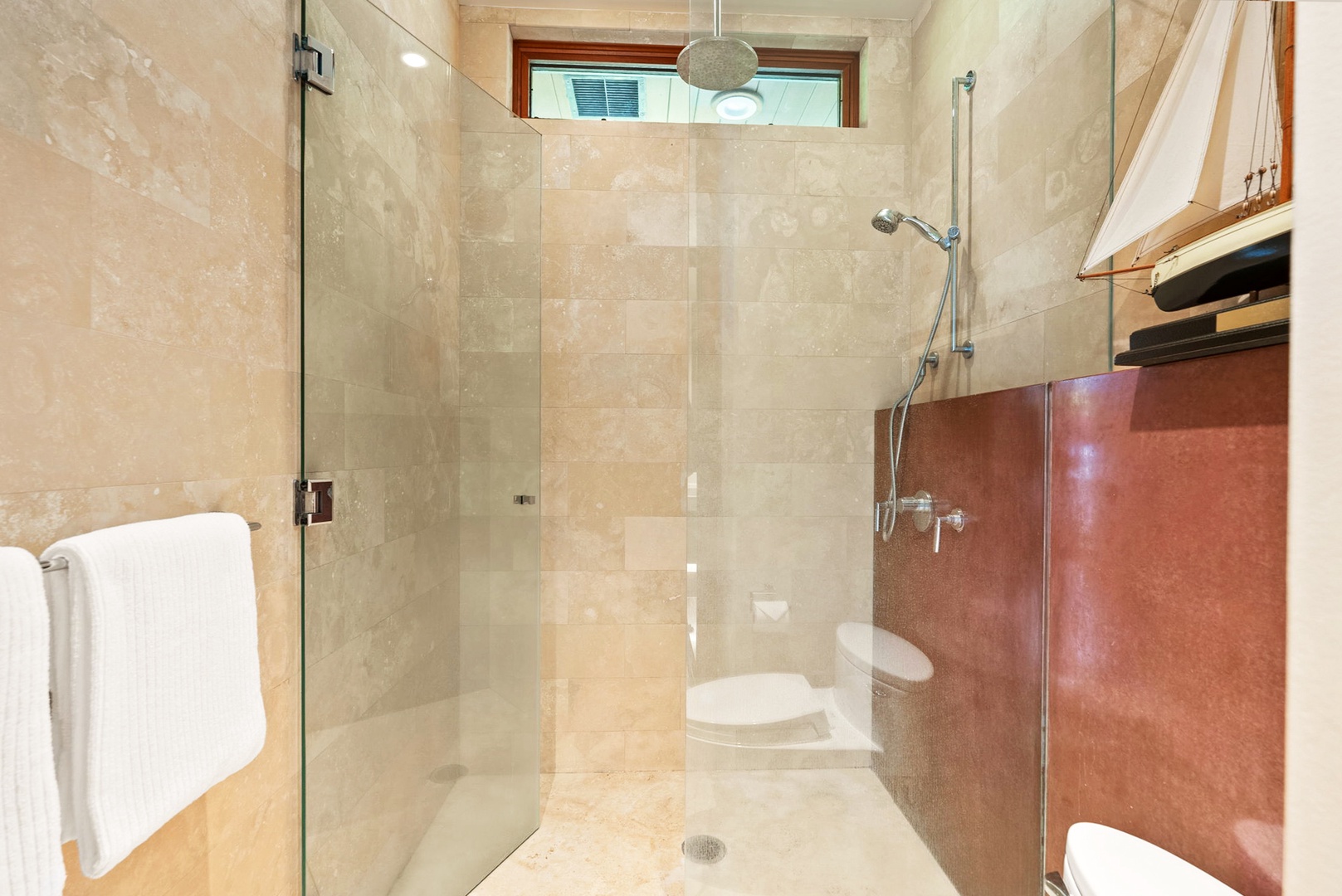 Kailua Vacation Rentals, Kailua Sands - Walk-in shower with stone tile and glass door.