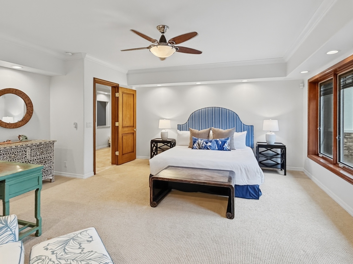Honolulu Vacation Rentals, Maunalua Estate - Your elegant bedroom features a plush bed with coastal-inspired decor, ceiling fan for comfort, and bright natural light streaming through beautiful windows.