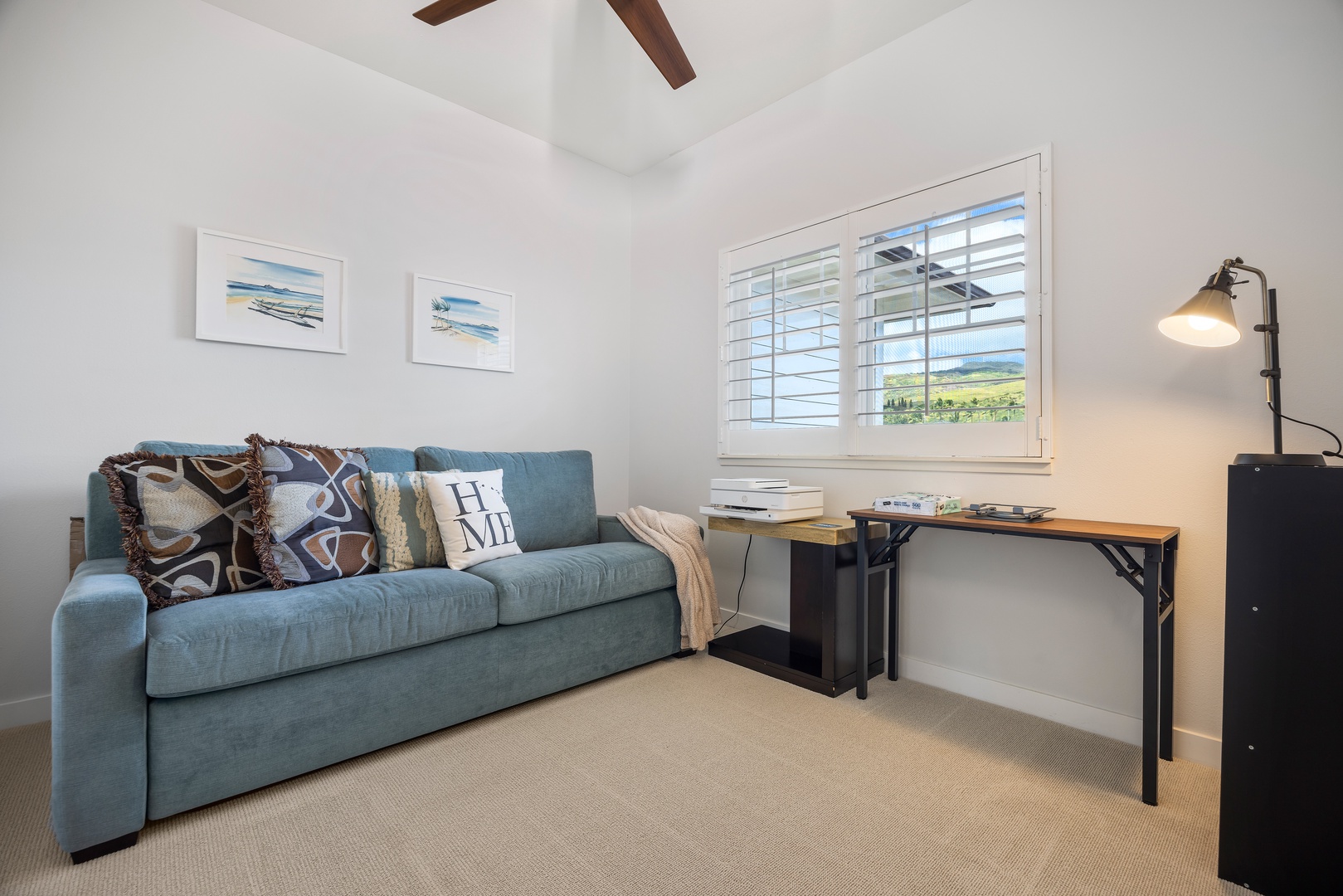 Your bright workspace combines comfort with productivity, featuring a cozy sofa and dedicated desk beneath exposed beams.