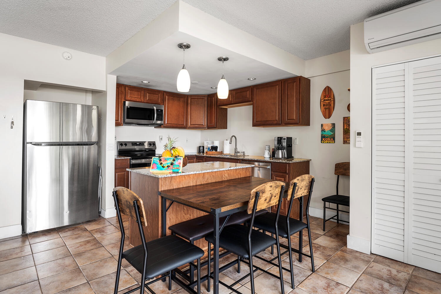 Kailua Kona Vacation Rentals, Kona Plaza 201 - Your fully-equipped kitchen invites culinary adventures with granite countertops, stainless steel appliances, and a cozy dining nook for memorable meals together.