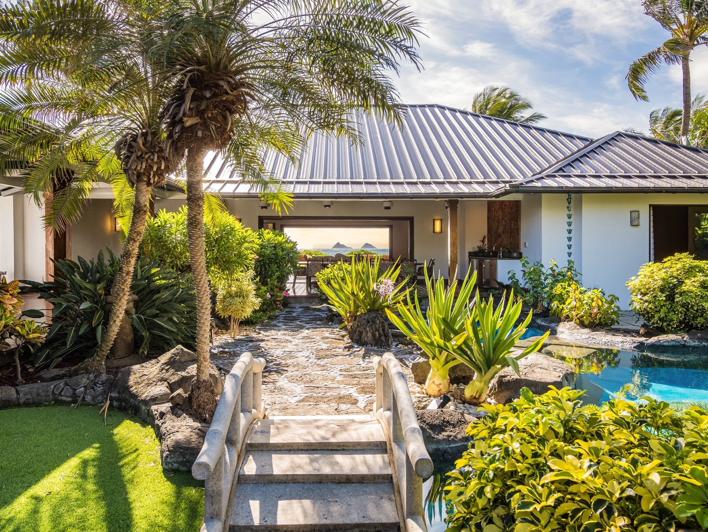 Kailua Vacation Rentals, Castle Point Estate - Signature tropical entryway framed by palm trees, flowers, and flowing water.