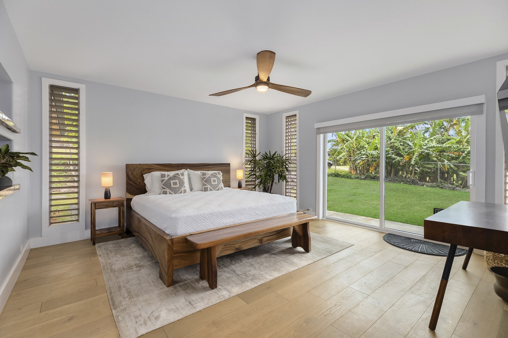 Haleiwa Vacation Rentals, Hale Mahina - Primary bedroom with king sized bed, study desk, and smart TV