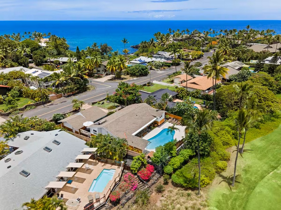Kailua Kona Vacation Rentals, Manukai Hale - An aerial view sets Manukai Hale among the trees with the ocean in the distance.